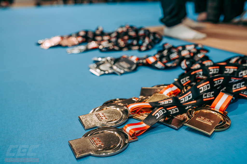 The full set of CEC medals laid out mat-side ahead of the podiums