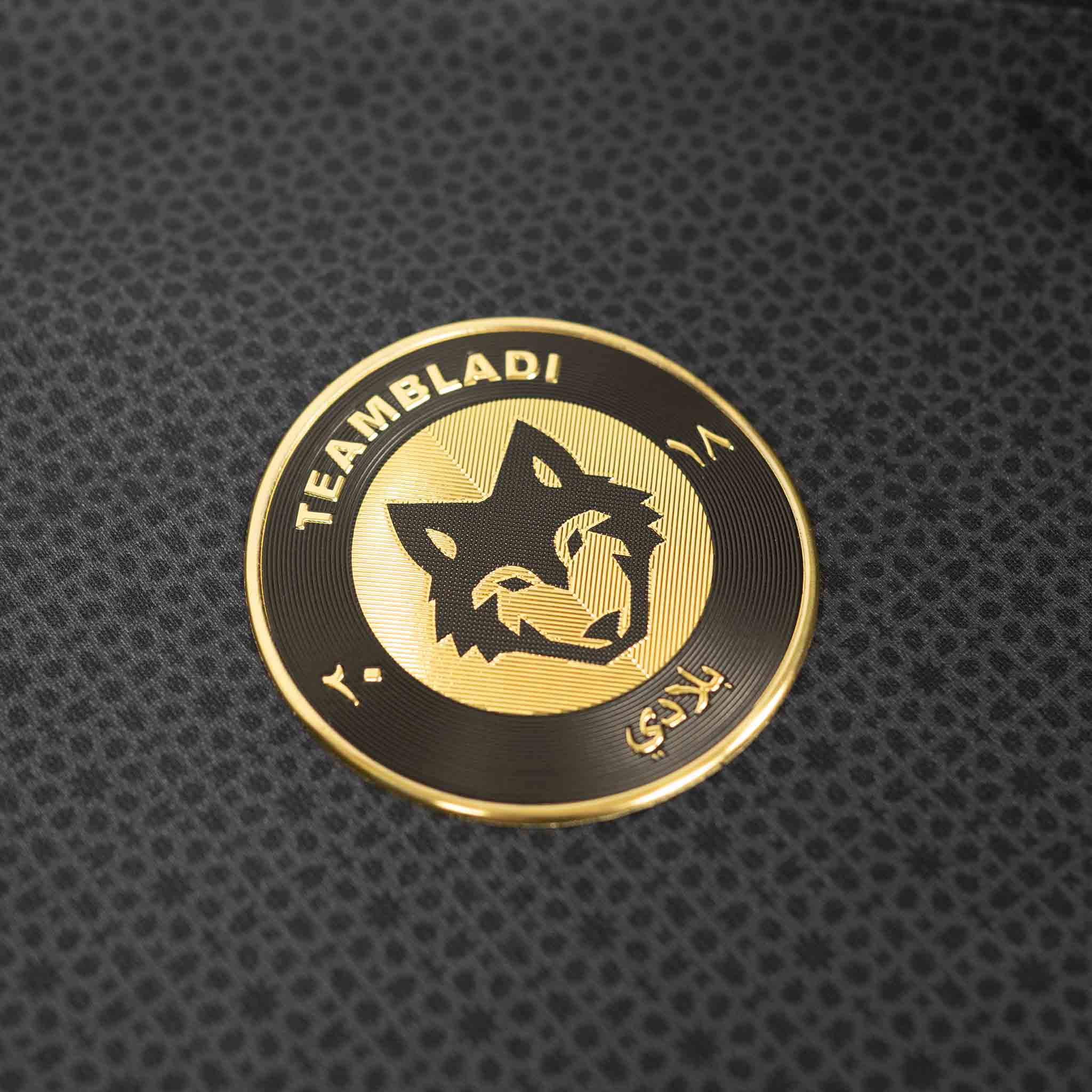 TEAMBLADI Equipe jersey — gold embroidered wolf logo patch detail